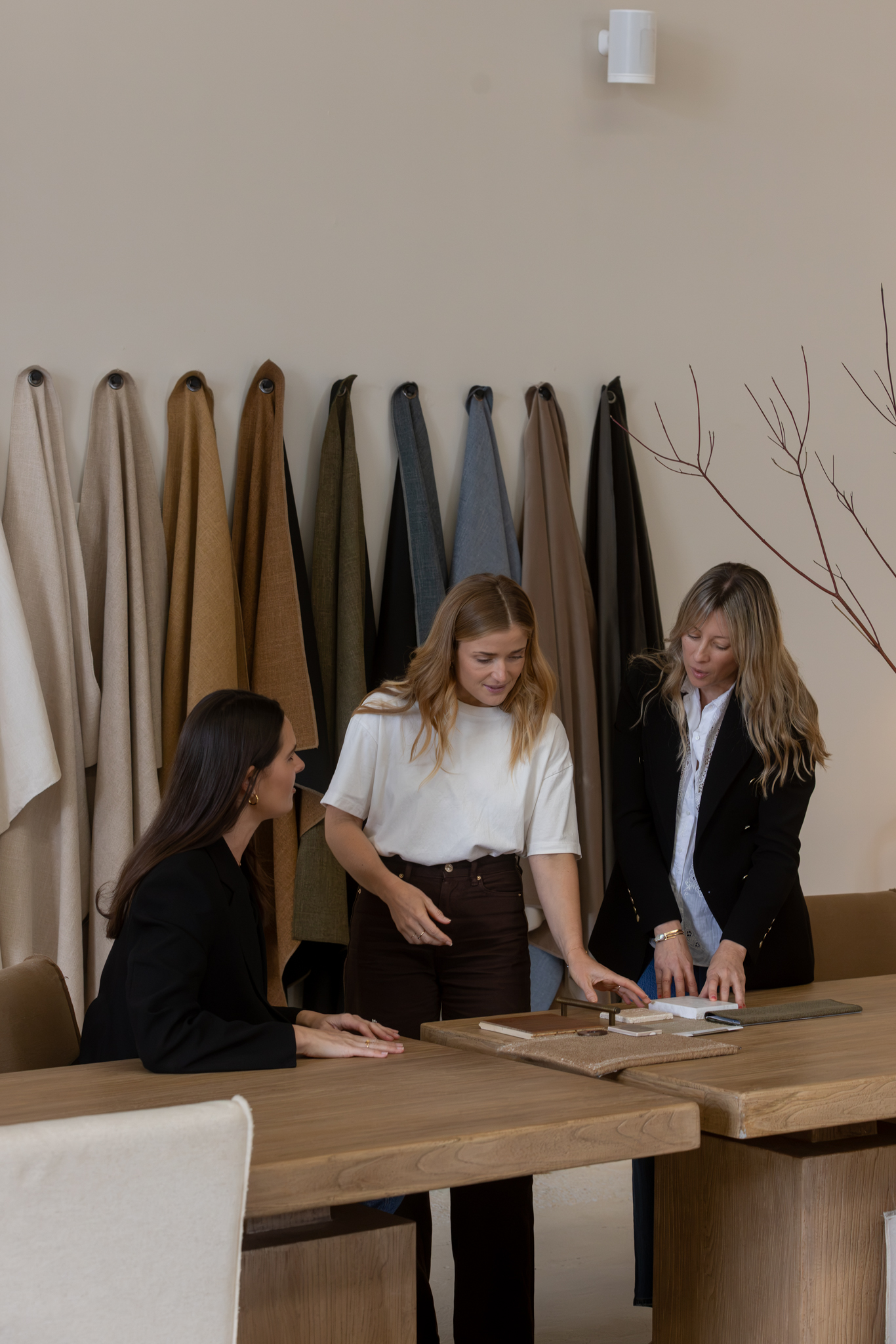 The Unfolded team reviewing fabric and material samples together at the Designing for the Senses event
